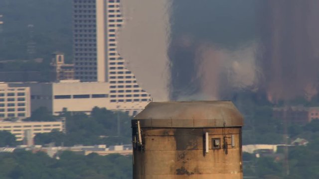 Aerial view of industrial smokestack emitting hot vapor