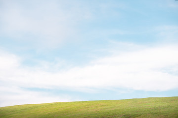 Green grass on the hills with clear blue sky