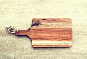Cutting board on wooden background