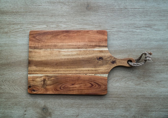 Cutting board on wooden background