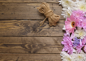 Flowers arranged on a rustic wooden background forming a page border