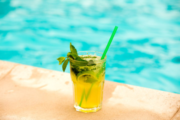 Mojito cocktail in a bur in summer bar, Alcohol cocktails with Rum, lime, mint, ice cubes and brown sugar closeup, Party drink.