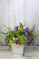 Floral arrangement with delphinium and matthiola flowers