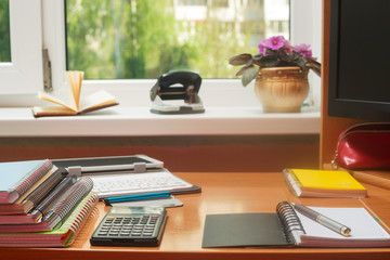 Office desk table with computer, supplies, flower. Copy space for text