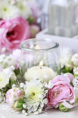 Beautiful wedding decorations: flower wreath around glass jar wi