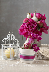 Floral arrangement with red peonies and candles