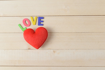 Colorful wood font arranged in a word love on wood background