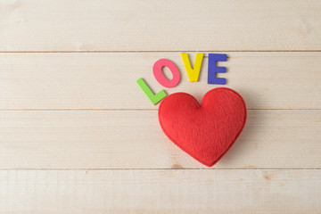 Colorful wood font arranged in a word love on wood background