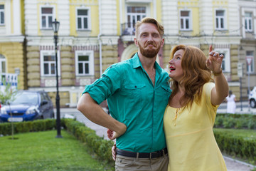 happy couple man and woman hugging in city