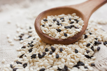 Sesame seeds in a wooden spoon closeup