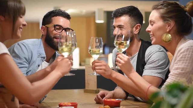 Group of trendy people cheering with wine glasses