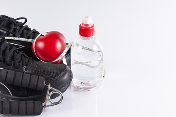Fitness background with bottle of water , shoes and heart