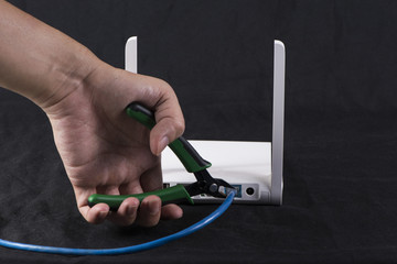 Hand cutting internet cable of router, communication concept