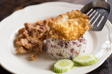 Rice topped with stir fried and fried pork