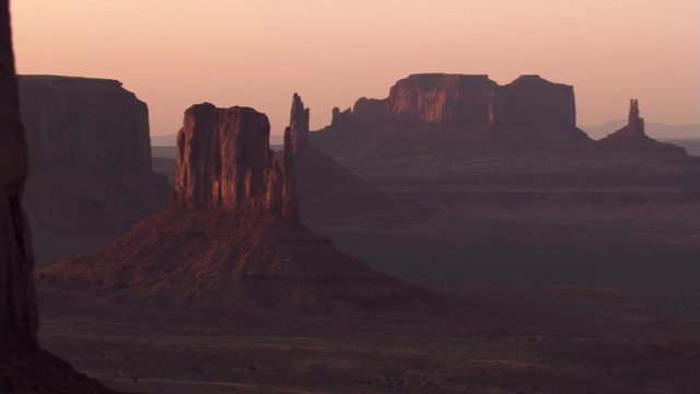 Close sunset flight past Three Sisters in Monument Valley