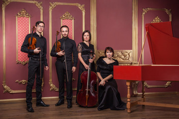 Classical music quartet posing after the concert.