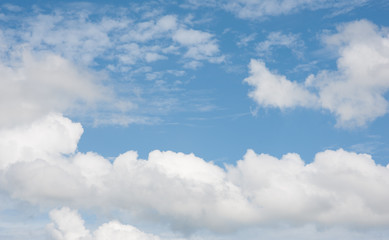 Blue summer sky with white clouds, natural background.