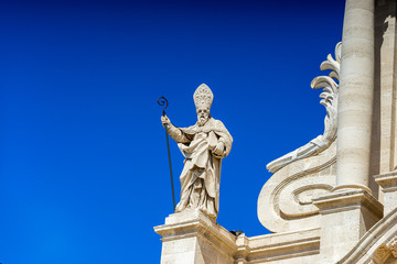 The statue of St. Peter and some baroque elements in the externa