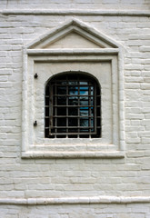 Fototapeta na wymiar Single barred window in brick wall