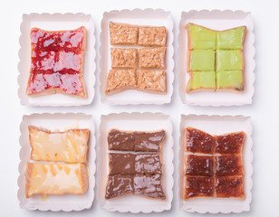 Sweetened condensed milk, strawberry jam, peanut butter on bread