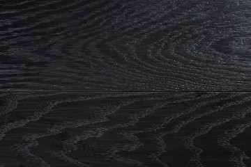 background of natural oak planks covered with black oil