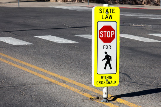 Stop for Pedestrians within crosswalk sign and crosswalk