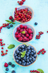 Fresh healthy berries in rustic bowls with mint
