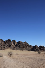 Fototapeta na wymiar Landscape in the desert, Egypt. Rocky hills. Blue sky.