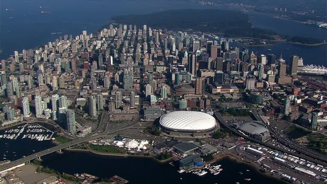 High, partial orbit of Vancouver, British Columbia, at a distance; BC Place stadium in center frame. Shot in 2003.