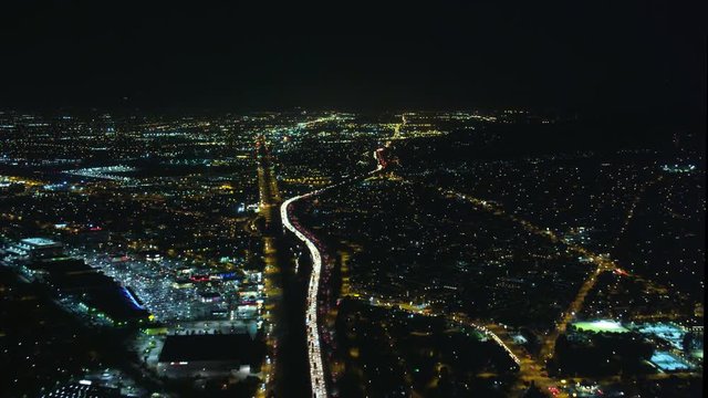 Timelapse flight over Los Angeles traffic at night, then approaching airport. Shot in 2010.