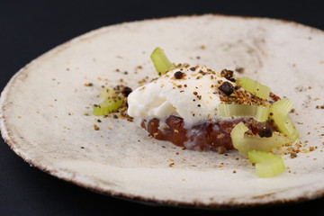 Piece of meat with a cream sauce decorated celery 