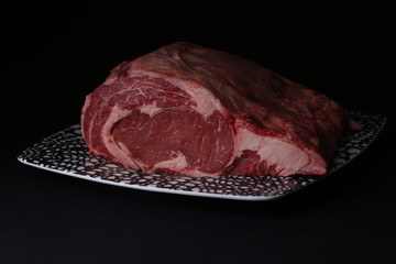 Piece of fresh red meat on plate. Close up