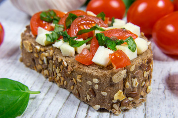 Ciabatta bread with tomatoes, mozzarella and basil.