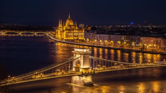 Aerial view of Chain bridge and Parliament building in Budapest, Hungary at night. Time-lapse
