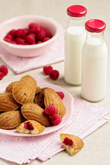 French pastry Madeleine with raspberries.