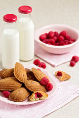 French pastry Madeleine with raspberries.