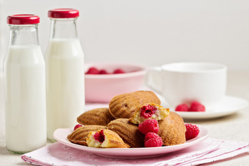 French pastry Madeleine with raspberries.