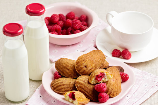French pastry Madeleine with raspberries.