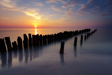 A breakwater on a sandy beach in Debki, Poland, Europe. Baltic sea.