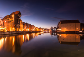 Gdansk old town with harbor and medieval crane in the night.