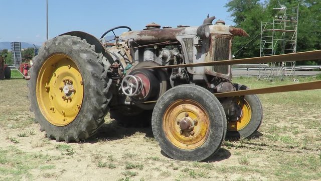 Old wheeled tractor used for threshing 