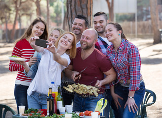 Adults doing selfie at picnic
