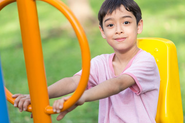 Asian kid boy play with exercise equipment