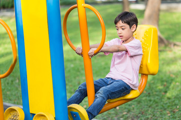 Asian kid boy play with exercise equipment