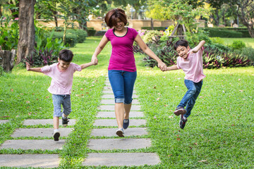 mother running in the park with sons
