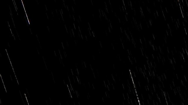 Falling raindrops footage animation in realtime on black background, black and white luminance matte, seamlessly looped rain animation, perfect for film, digital composition, projection mapping