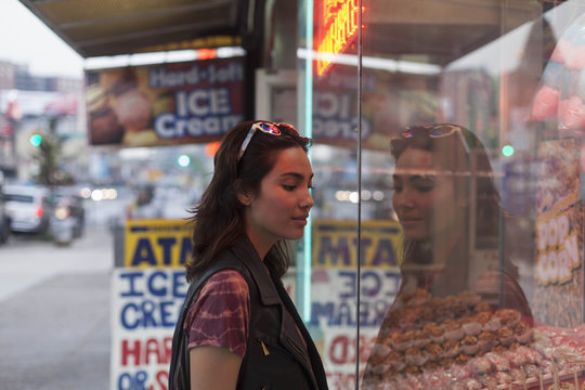 Young woman looking at a store front