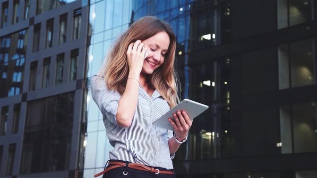 beautiful businesswoman with mobile on the background of the business center