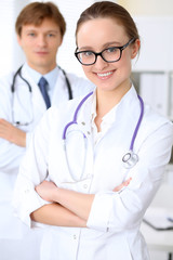 Fototapeta premium Happy doctor woman with medical staff at the hospital