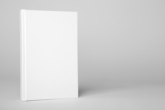 Real hardcover white book on a gray background